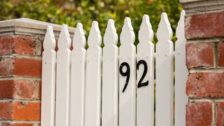 number 92 on white picket gate
